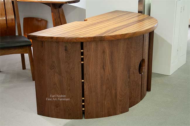 home office desk showing side panels with pegs and curved design
